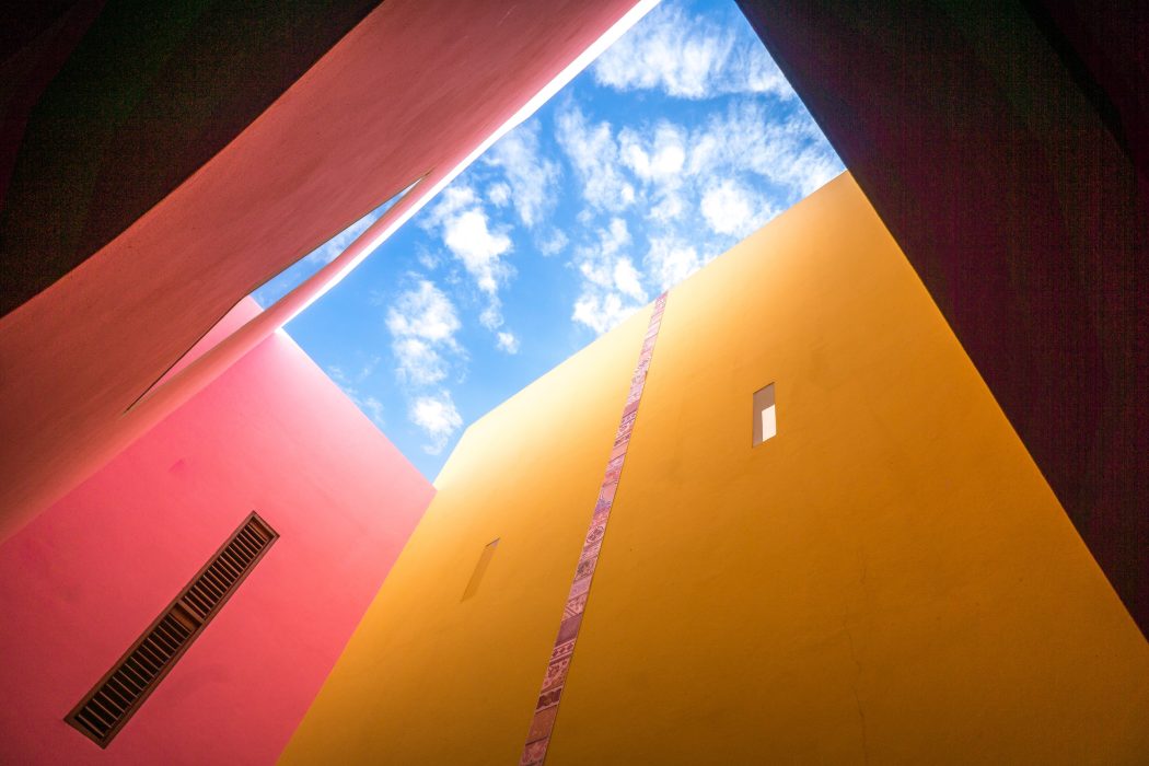 colorful walls looking up to a blue sky