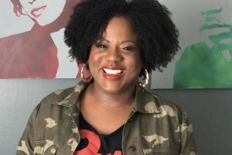 Headshot of Toya wearing a colorful graphic t-shirt