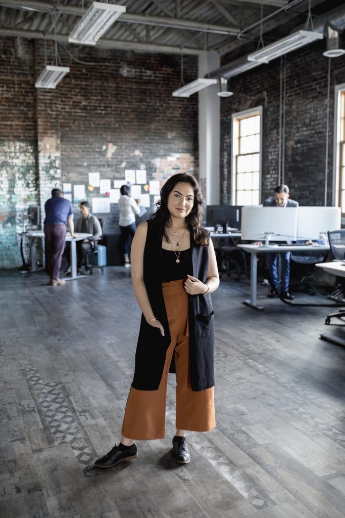 Confident creative woman in loft office 
