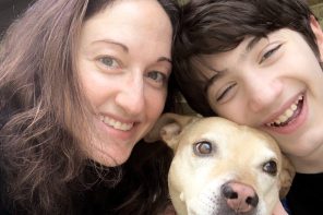 Liz smiling with son and dog